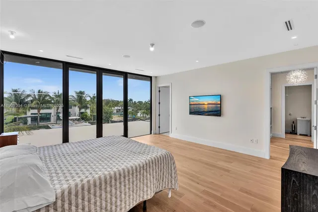 a large bedroom with a large bed and a large window