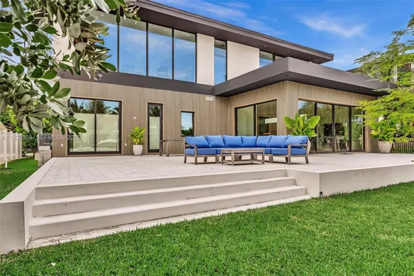 a view of a backyard with plants and a patio