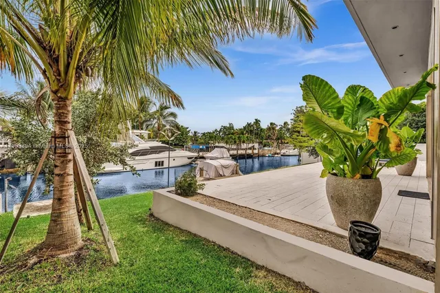 a view of a backyard with plants and a patio