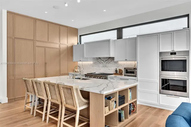 a kitchen with a stove a sink and a refrigerator