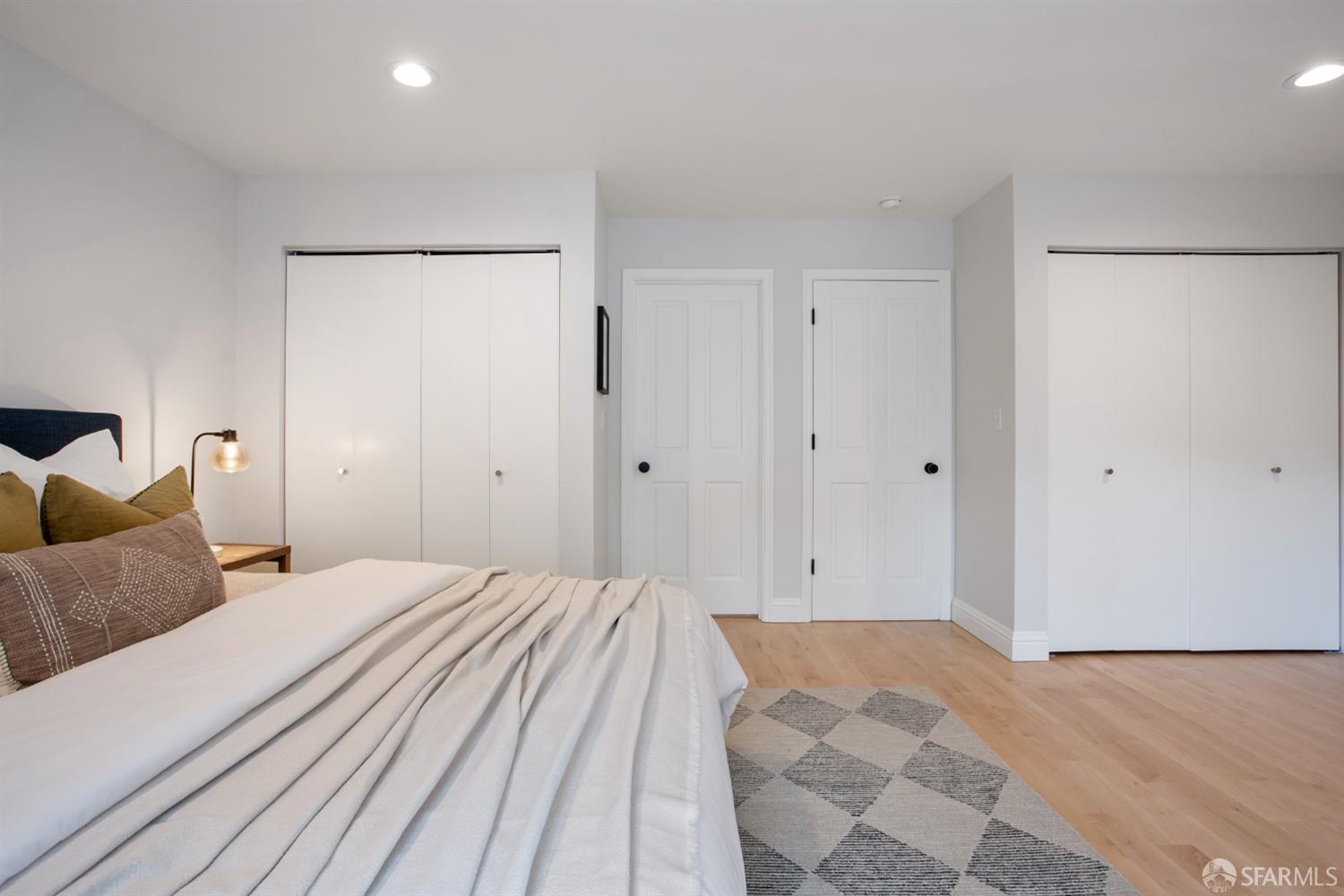 251 Ripley Street San Francisco, CA 94110 - Photo 15 of 39 a bedroom with a bed and a walk in closet
