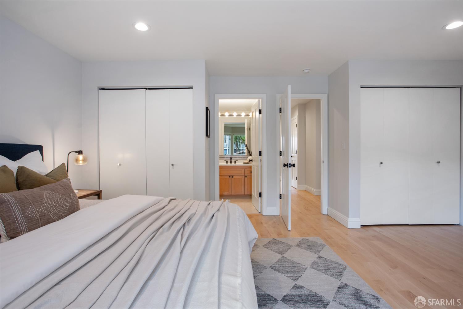 251 Ripley Street San Francisco, CA 94110 - Photo 16 of 39 a bedroom with a large bed and a chandelier
