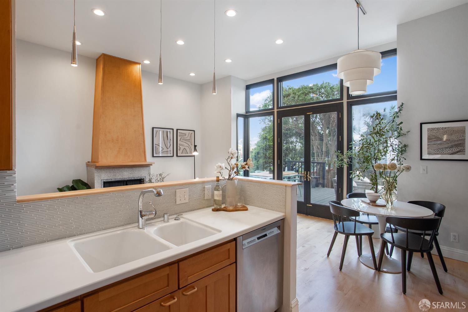 251 Ripley Street San Francisco, CA 94110 - Photo 27 of 39 a kitchen with a table chairs sink and wooden floor
