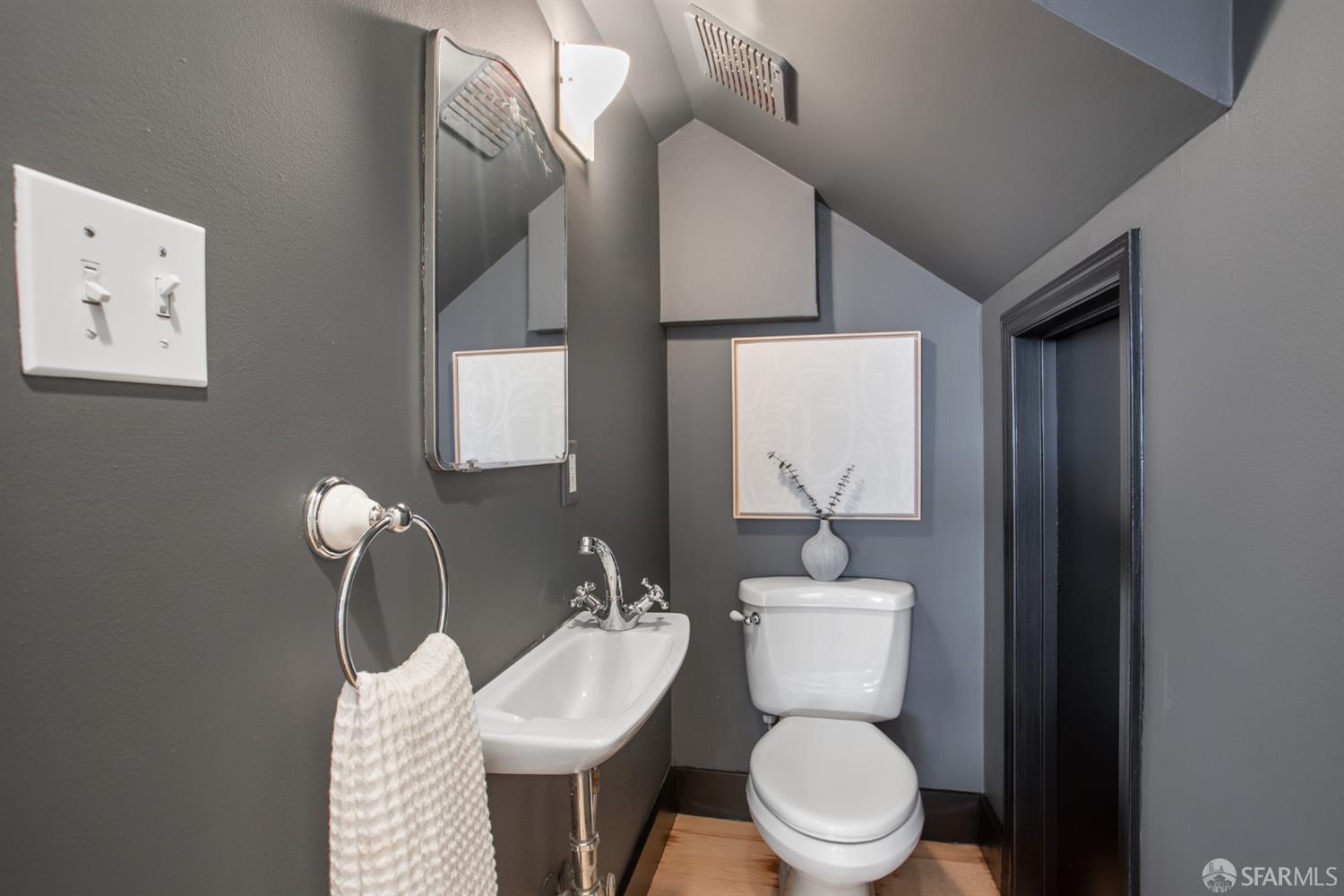 251 Ripley Street San Francisco, CA 94110 - Photo 33 of 39 a bathroom with a toilet a sink and mirror