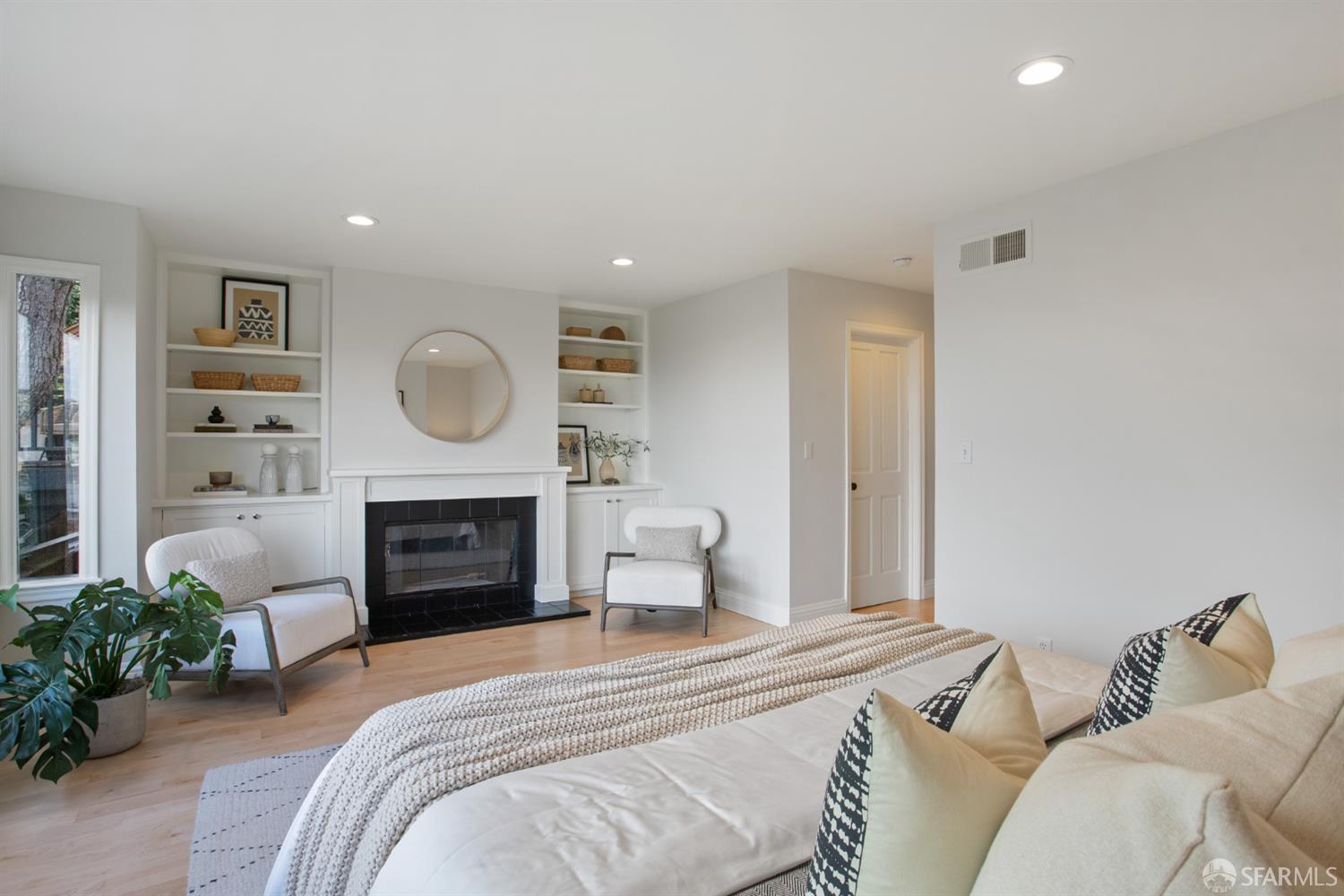 251 Ripley Street San Francisco, CA 94110 - Photo 5 of 39 a bedroom with a bed and a fireplace