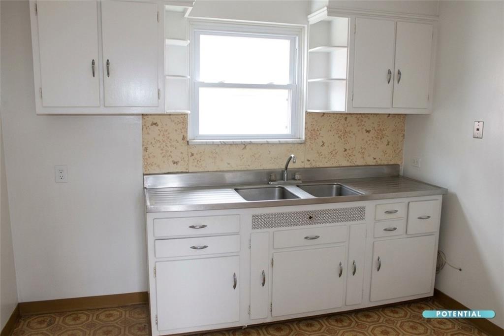 825 Liberty Street Duquesne, PA 15110 - Photo 20 of 25 a kitchen with white cabinets white appliances and a window