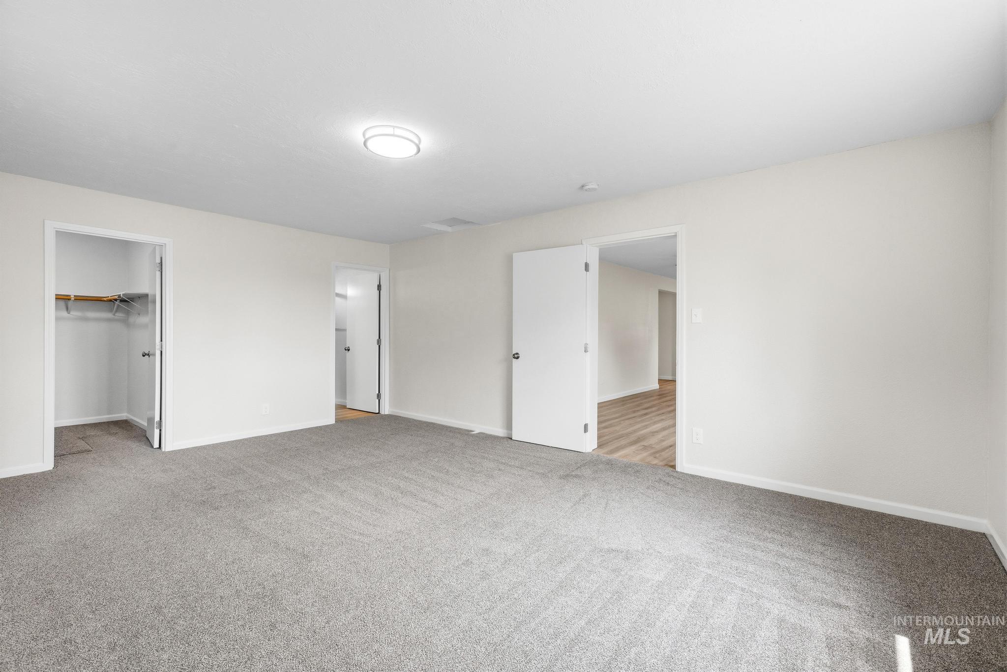 14666 Willis Road Caldwell, ID 83607 - Photo 24 of 50 Spacious room featuring light gray carpeting and neutral wall tones