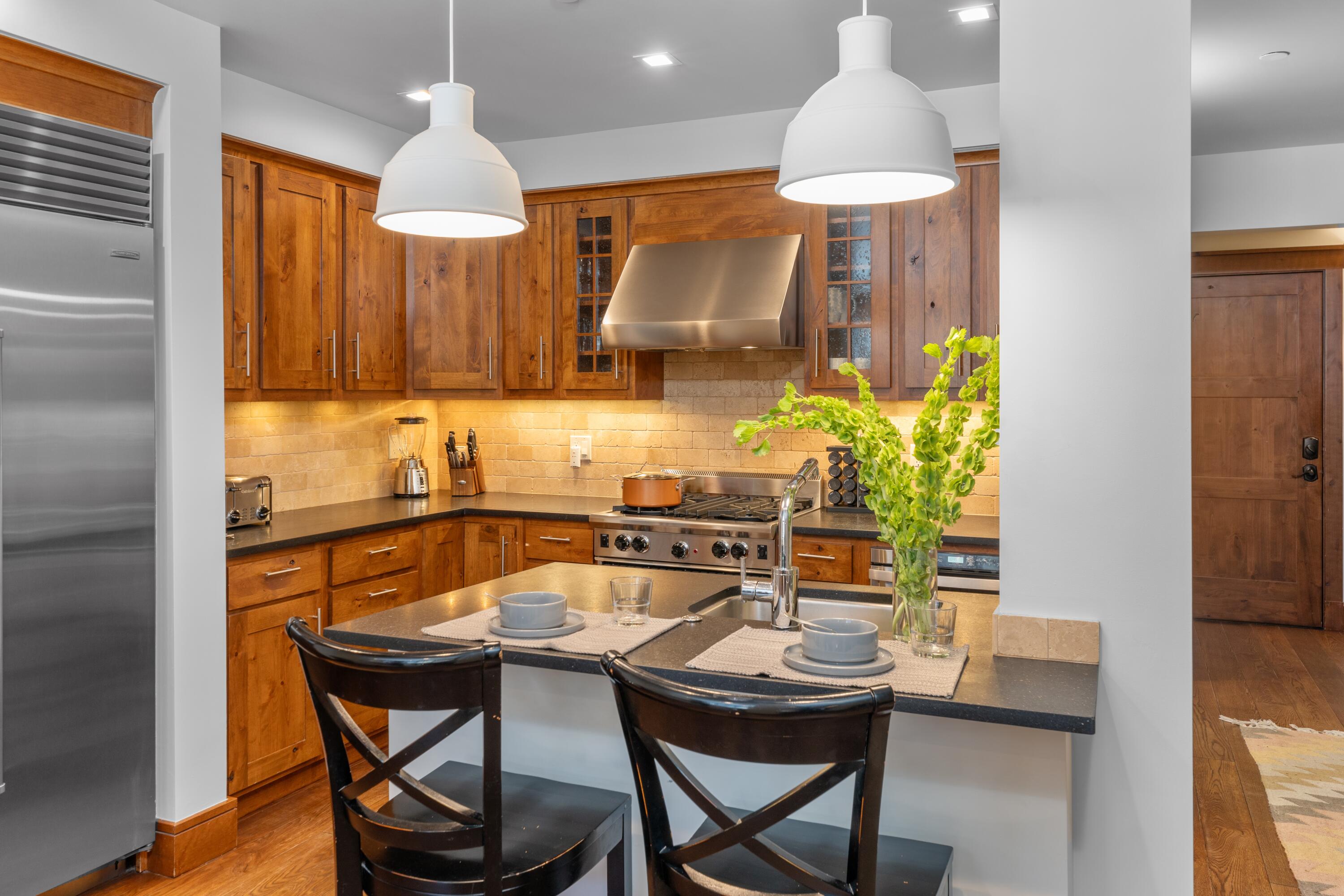 230 South Pine Street, Unit R 102 Telluride, CO 81435 - Photo 5 of 14 a kitchen with a table and chairs in it