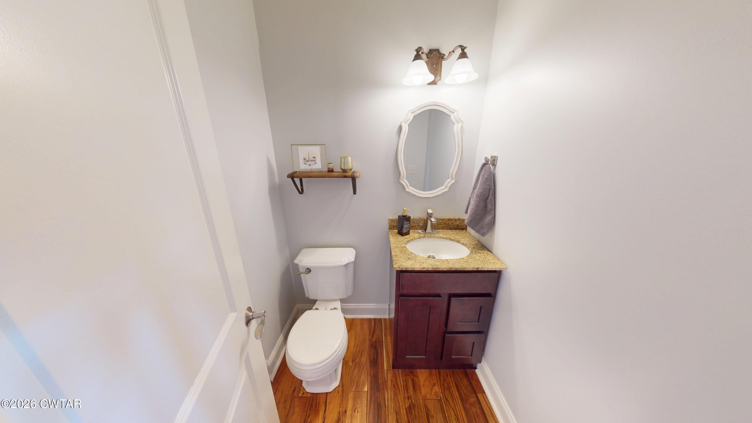 740 Gordon Road Dyersburg, TN 38024 - Photo 22 of 48 a bathroom with a toilet mirror and vanity