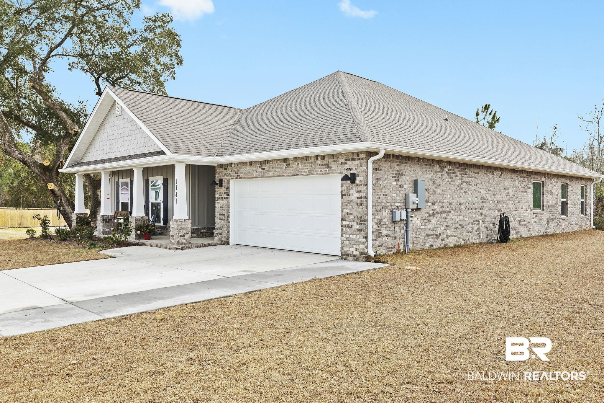 1141 Pencarro Boulevard Foley, AL 36535 - Photo 5 of 70 View of front of home featuring a porch and a garage