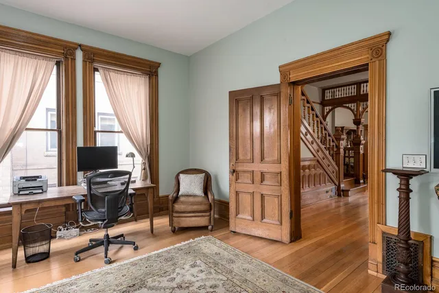 a view of a livingroom with workspace and a window