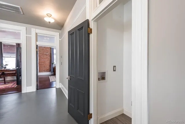 a view of a hallway with wooden floor