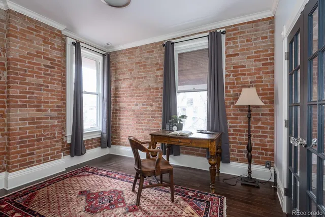 a view of a workspace with furniture and a window