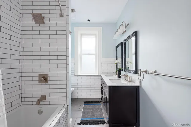 a bathroom with a sink a bathtub and a mirror