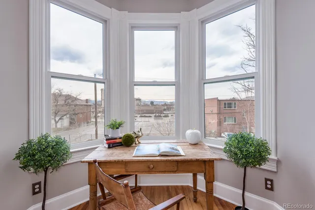 a view of a workspace with a table and chair in a room