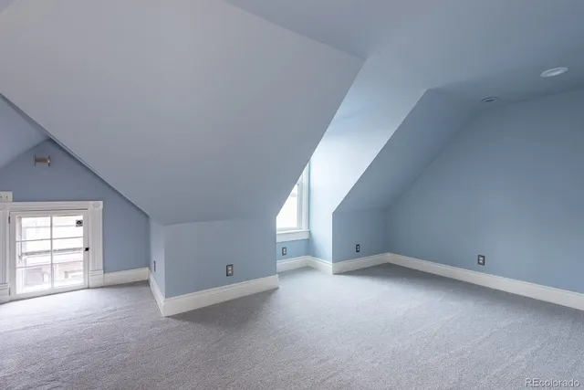 a bathroom with a sink vanity granite tub and a mirror