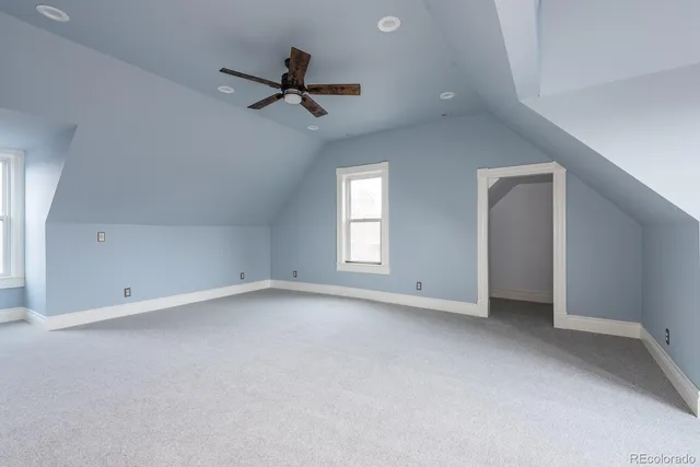 an empty room with closet and a ceiling fan