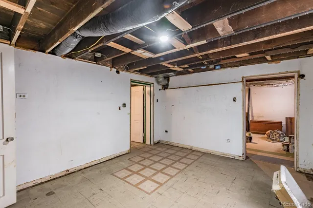 a utility room with dryer washer and a view of kitchen
