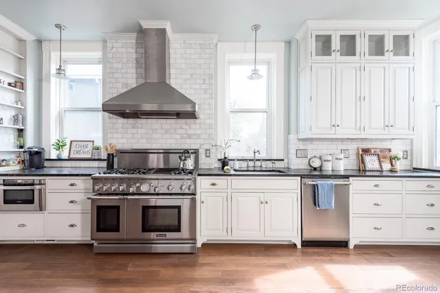 a kitchen with stainless steel appliances granite countertop a stove and a sink