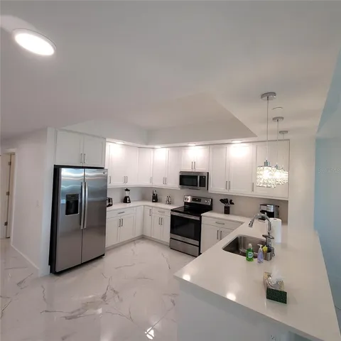 a kitchen with counter top space cabinets and stainless steel appliances