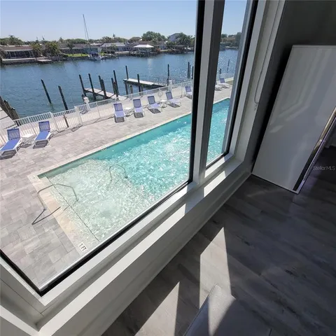 a large white bed in a white room