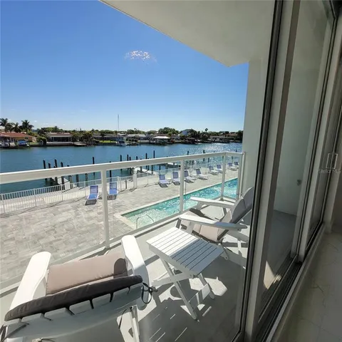 a view of a balcony with couple of chairs