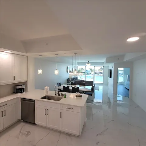 a kitchen with counter top space and living room
