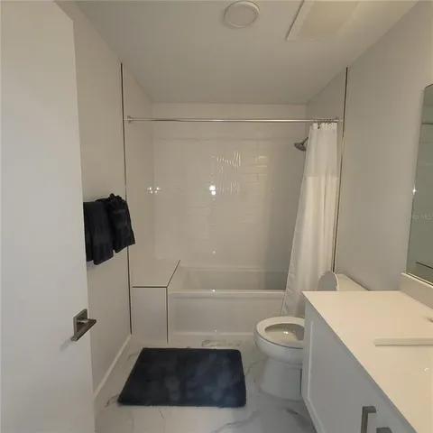 a bathroom with a toilet a sink and a shower