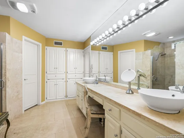 a bathroom with a sink double vanity and a mirror