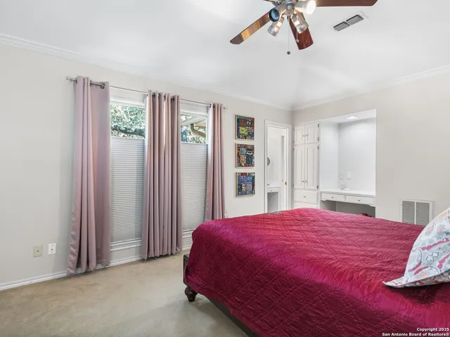a kitchen with granite countertop white cabinets and chairs