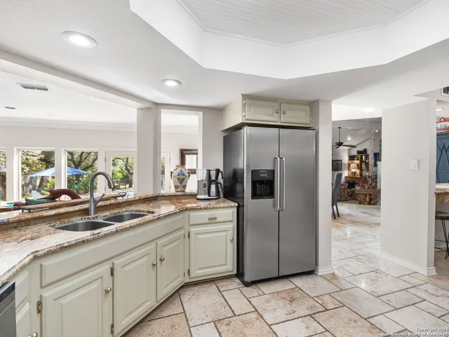 a kitchen with stainless steel appliances granite countertop a sink and cabinets