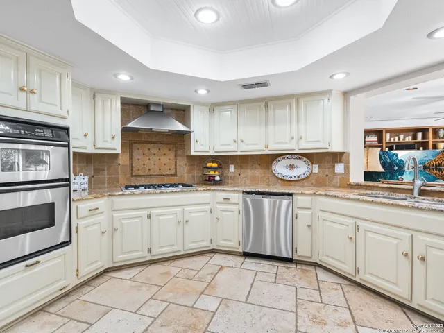 a view of a dining room with furniture large windows and wooden floor