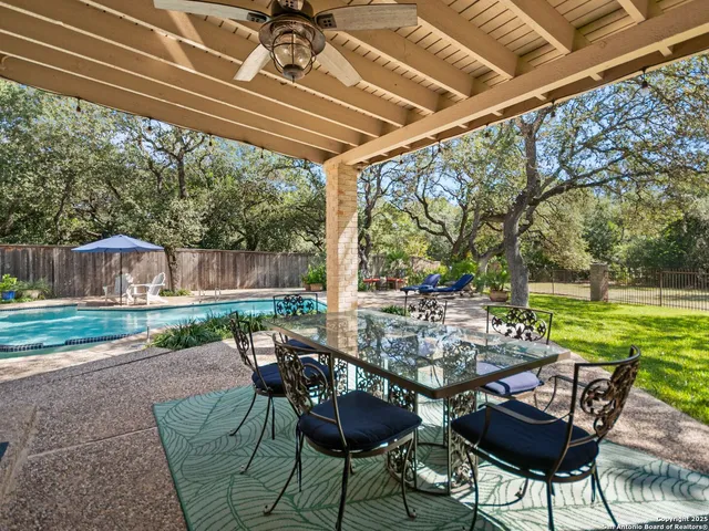a view of a patio with chairs and table in patio