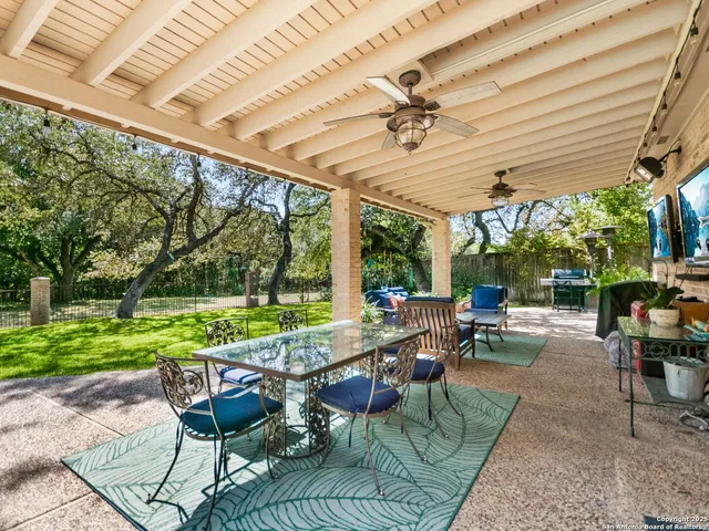 a view of a patio with table and chairs potted plants