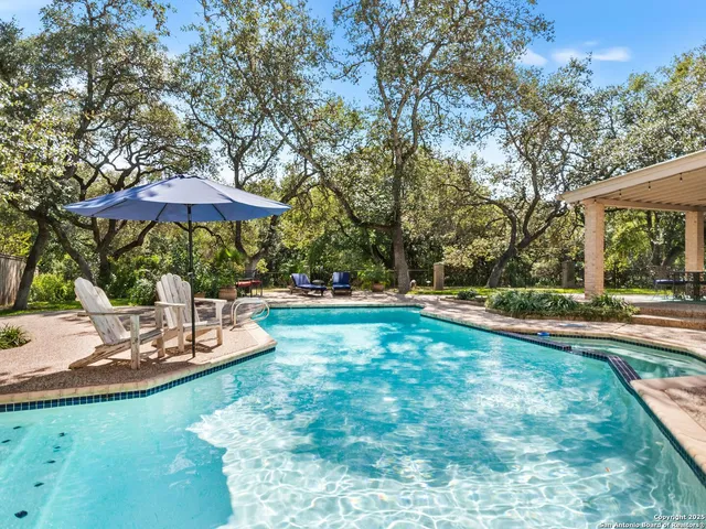 a view of a house with a yard patio and swimming pool