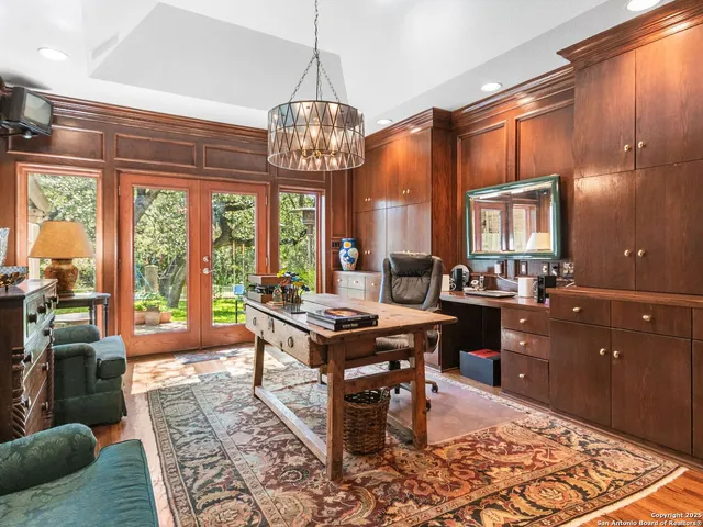 a view of a dining room with furniture a chandelier and wooden floor