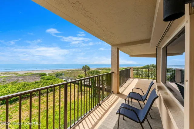 a view of a city from a balcony with furniture