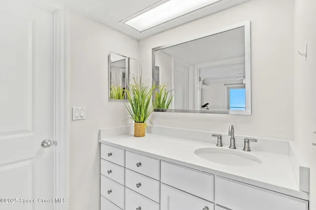 a bedroom with two beds and a large window