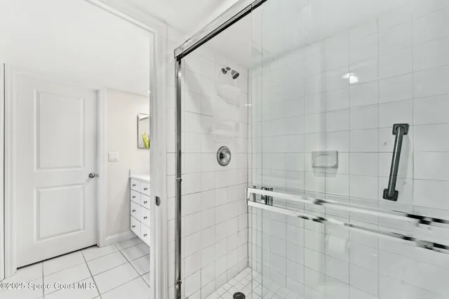 a bedroom with a bed and a large window with the outer view