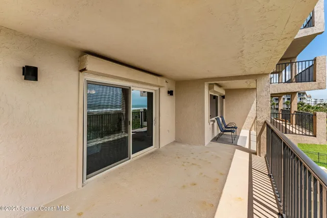 a room with pool table and chairs