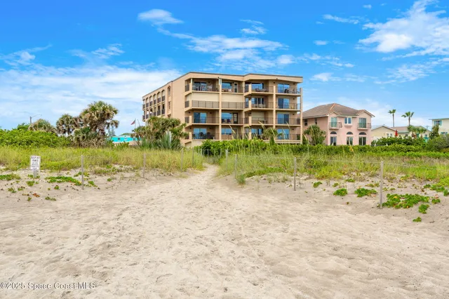 a view of a house with a palm tree