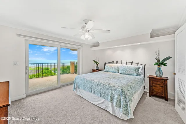 a spacious bedroom with a bed and a chandelier