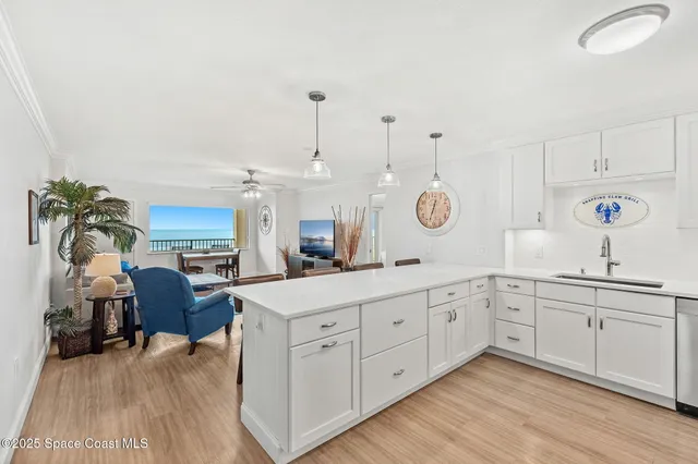 a large kitchen with cabinets and wooden floor