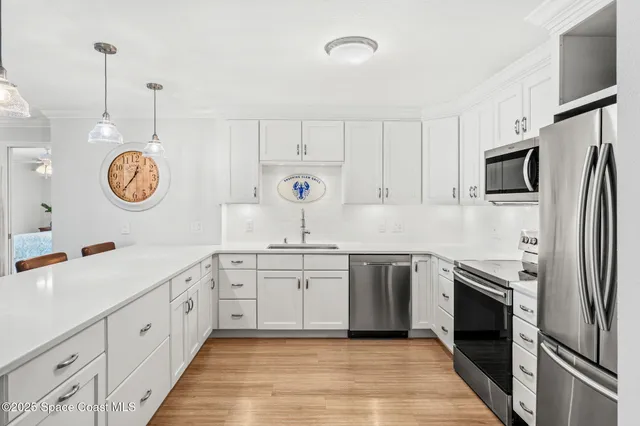 a kitchen with cabinets stainless steel appliances and a counter space