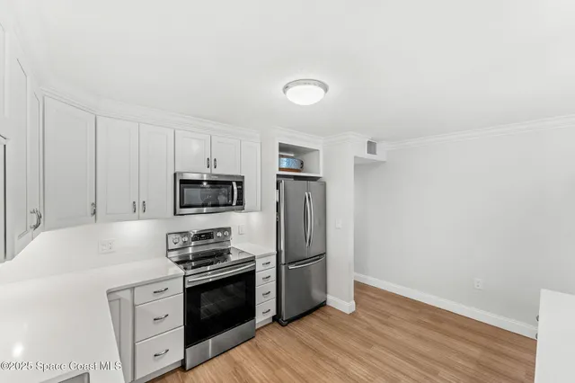 a kitchen with wooden cabinets and stainless steel appliances