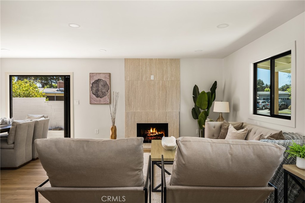 2680 Chatwin Avenue Long Beach, CA 90815 - Photo 12 of 61 a living room with furniture a fireplace and a large window