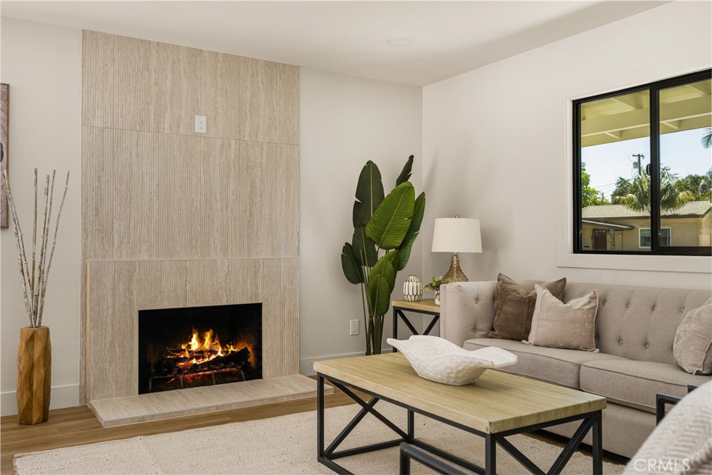2680 Chatwin Avenue Long Beach, CA 90815 - Photo 21 of 61 a living room with furniture a window and a fireplace
