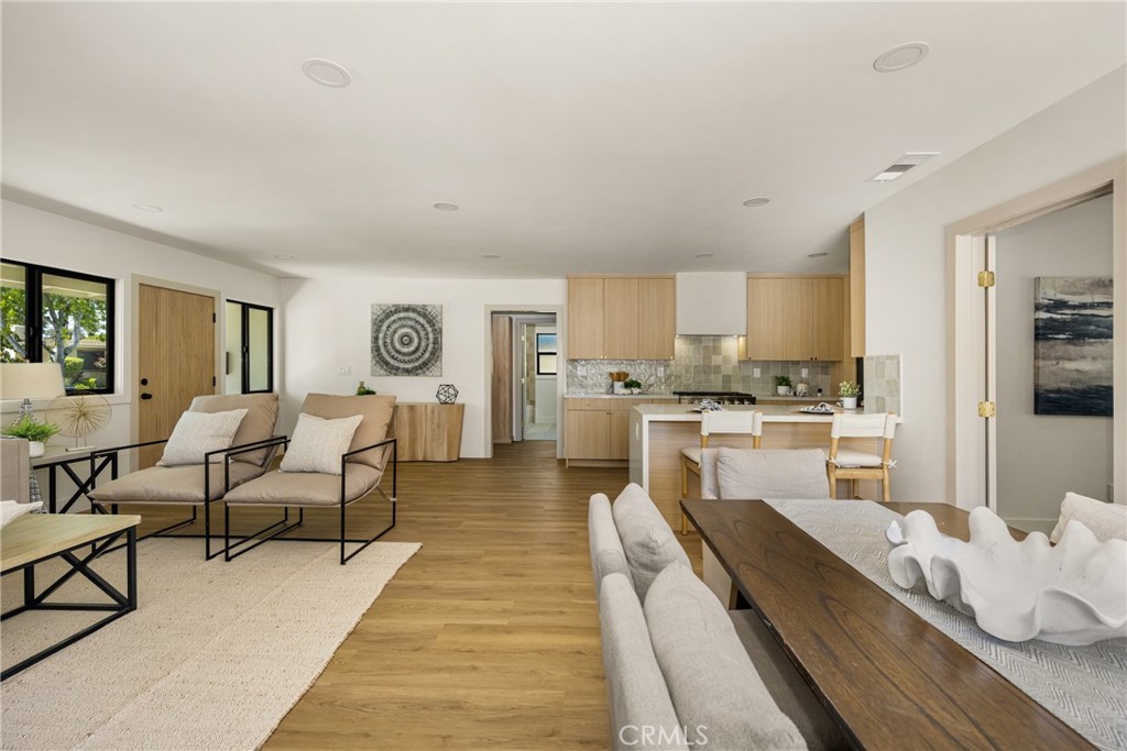 2680 Chatwin Avenue Long Beach, CA 90815 - Photo 24 of 61 a living room with granite countertop couches a coffee table and kitchen view with wooden floor