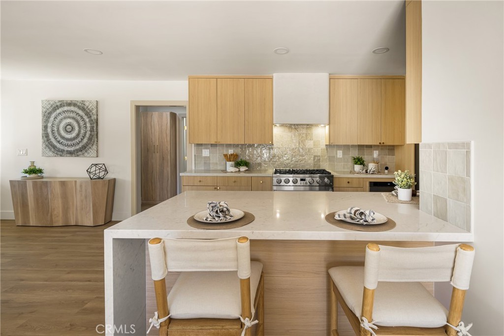 2680 Chatwin Avenue Long Beach, CA 90815 - Photo 28 of 61 a kitchen with a table chairs stove and cabinets