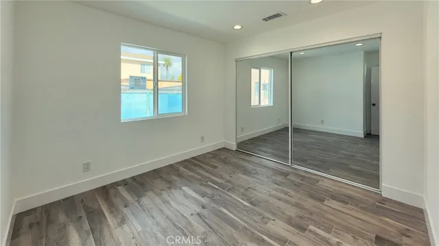 a view of wooden floor and windows in a room